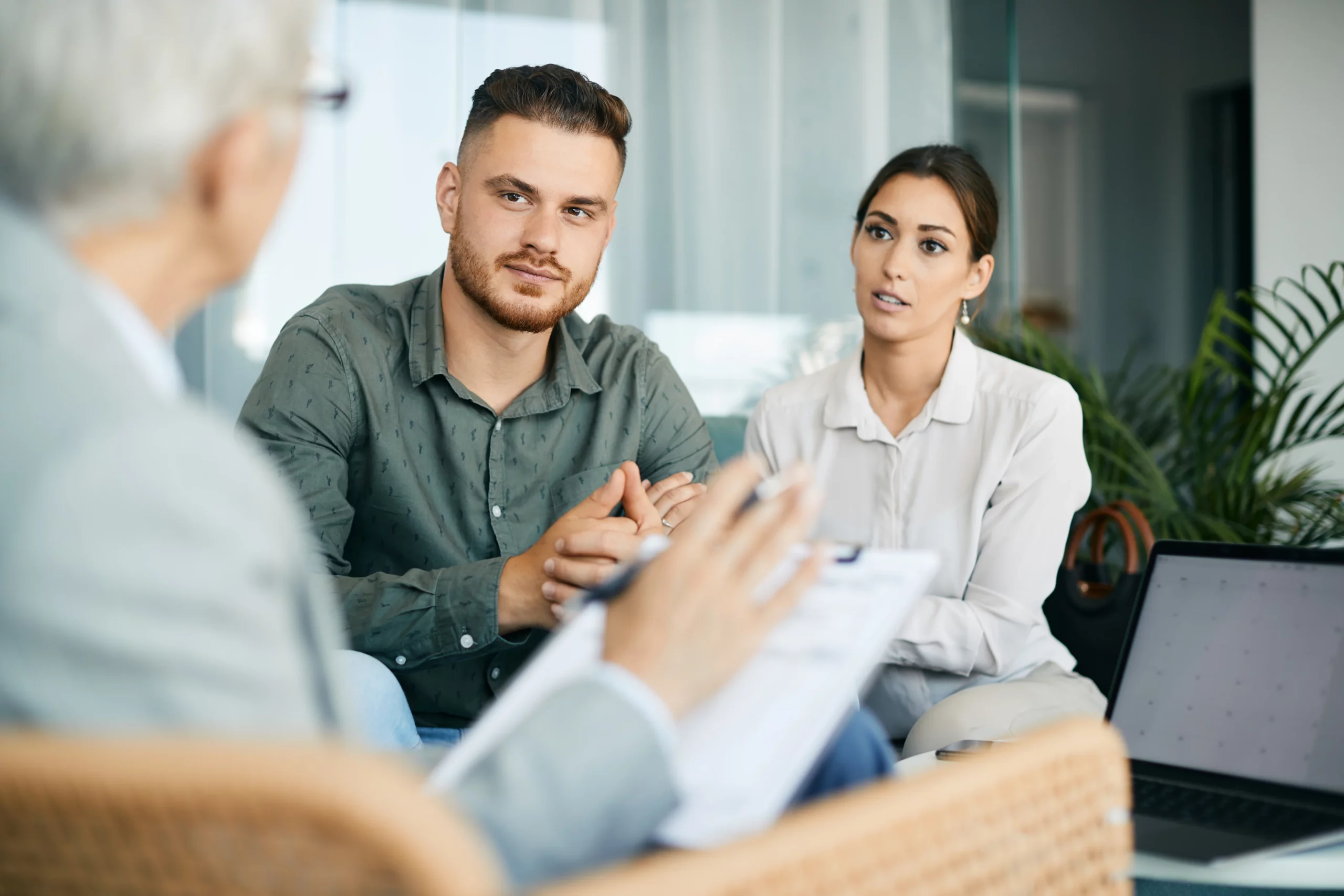 Couple meeting with estate planning professional to discuss revocable and irrevocable trusts in California