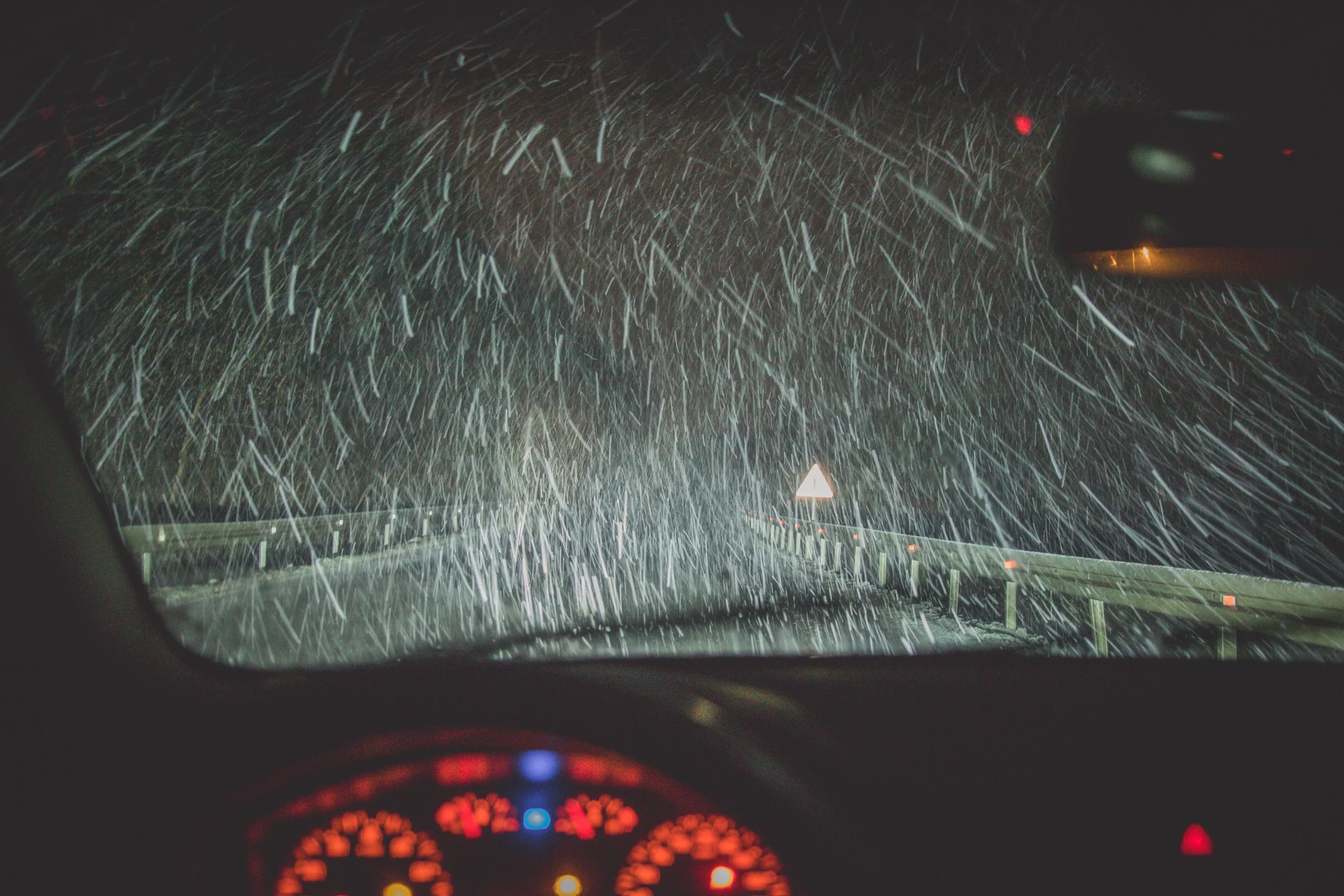 Driving at night in heavy snow showing hazardous road conditions